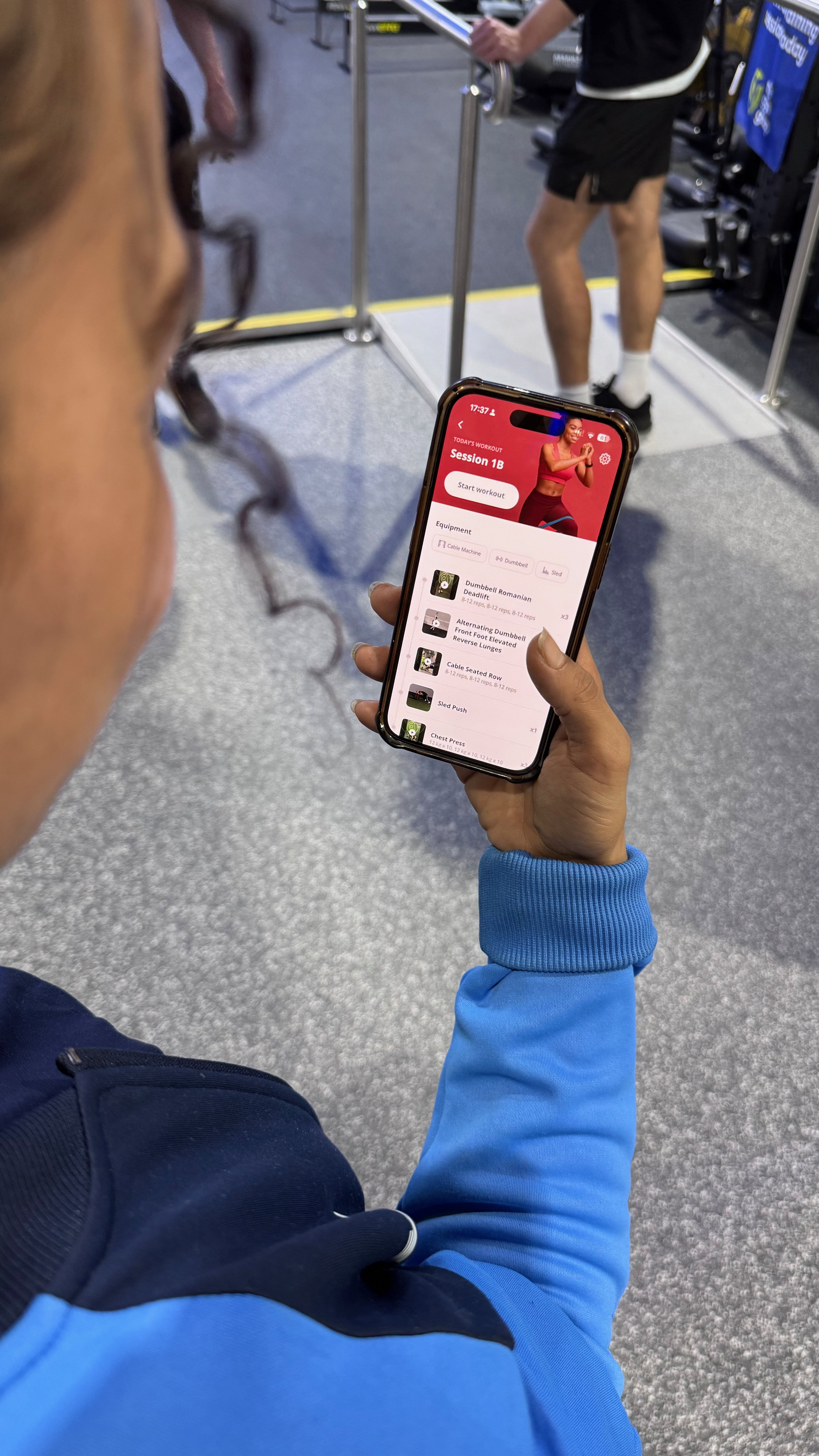 Client using Brady's online coaching app in the gym